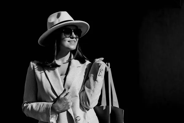 Stock image Beautiful brunette businesswoman wearing suit and white hat, walking on the street. Beautiful woman walking to the meeting