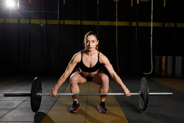 Woman with barbell Caucasian female performing deadlift exercise with barbell. Healthy Lifestyle