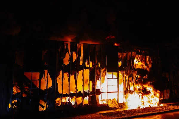 Intense Fire Burning Inside Building at Night