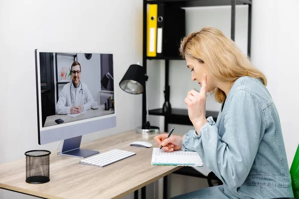 Caucasian doctor video conference call online live talk follow up remotely in medical result with woman sitting at chair at home. Online health care digital service concept