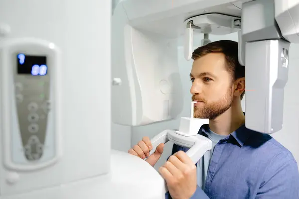 Panoramic image of teeth. A patient in a modern dental clinic takes a panoramic picture of the teeth. Prevention of dental diseases. Accurate diagnosis.Side view.