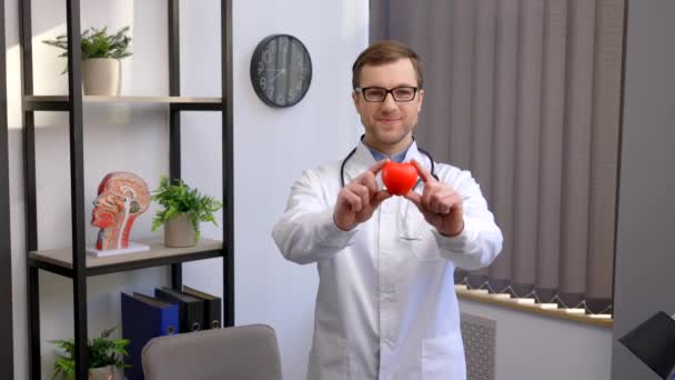 Doctor White Coat Glasses Holding Red Heart Hospital Office Medical — Vídeo de Stock