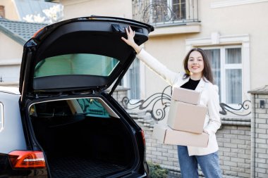 Genç bir iş kadını bir araba bagajından paketler alıyor, arabayla eve geliyor. Kız bagajı kapatmak için düğmeye basıyor..