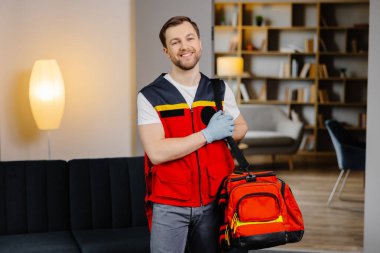 İlk yardım kursu. Omuzlarında çanta olan genç bir sağlık görevlisi dersten önce bir sınıfta duruyor..