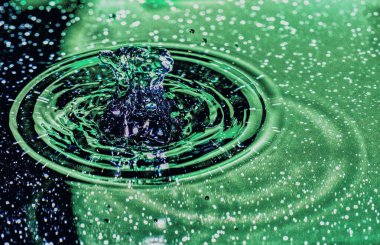 Su sıçratma - renkli makro karede düşen bir su damlası