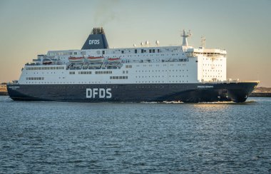 Ijmuiden, The Netherlands, 28.02.2023, Ferry to Newcastle of Danish international shipping and logistics company DFDS leaving the habrour of Ijmuiden clipart