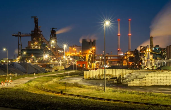 Factory Tata Steel with smoking chimneys on a sunny day, IJmuiden, The  Netherlands Stock Photo