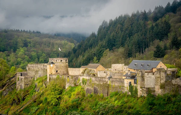 Bouillon Castle and the forests of the Ardennes in Belgium on a misty morning