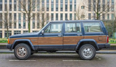 Amsterdam, Hollanda, 30.03.2024, 1990 yılından kalma klasik spor arazi aracı Jeep Wagoneer K6 'nın yan görüntüsü
