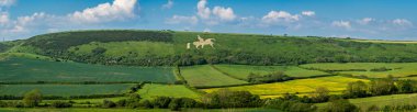 1808 'den kalma Osmington Beyaz At Tepesi figürü Weymouth, Dorset yakınlarında yer almaktadır.