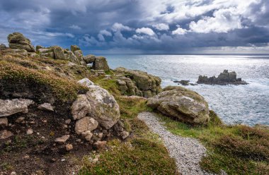 Coastal landscape of Land's End in Cornwall on a stormy afternoon clipart