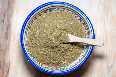 Za'atar blend of herbs in a bowl popular in Mediterranean region of the Middle East clipart