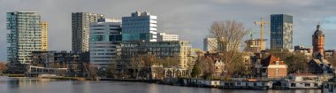 Panorama of Amsterdam Amstelkwartier, A Modern Neighborhood by the Amstel River clipart