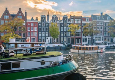 Autumn Sunset in Amsterdam, Amstel River Waterfront with Traditional Canal Houses and Houseboats