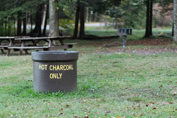 Hot charcoal disposal container in a picnic area in Pennsylvania.