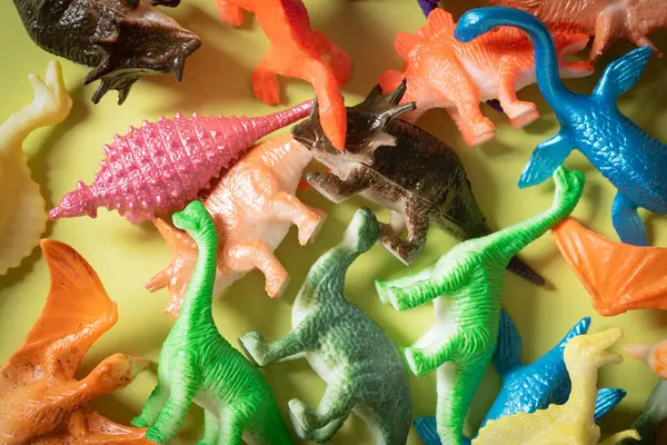Toy dinosaurs background.  Toy dinosaurs background.  Colorful pile of plastic, toy dinos.