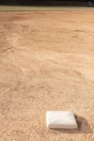 A base on a baseball field in the dirt.  Baseball background.