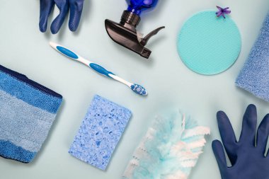 Açık mavi arka planda mavi ve beyaz temizlik malzemelerinin gölgeleri.