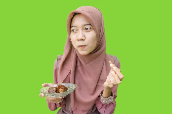 美丽的亚洲女人 带着绿色背景吃早餐的日期 穆斯林妇女头戴伊斯兰头巾和斋月观念的照片 — 图库照片