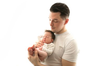 Close up portrait of young father and newborn baby. Father holds in his arms, gently hugs, kisses a beautiful newborn daughter. The concept of love, happy fatherhood. Photo on a white background. 