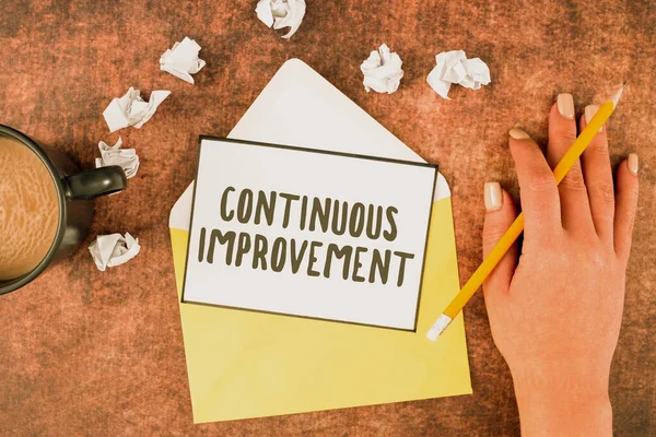 stock image Sign displaying Continuous Improvement, Word Written on making small consistent improvements over time Woman With Sheet, Envelope, Coffee Cup, Pencil And Crumpled Papers.