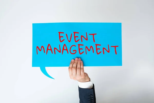 Text showing inspiration Event Management, Business concept everything that happens is part of a bigger picture Businessman Holding Speech Bubble With Important Messages With One Hand.