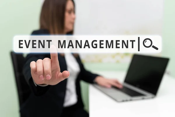 Text sign showing Event Management, Business concept everything that happens is part of a bigger picture Woman Typing Updates On Lap Top And Pointing New Ideas With Pen.