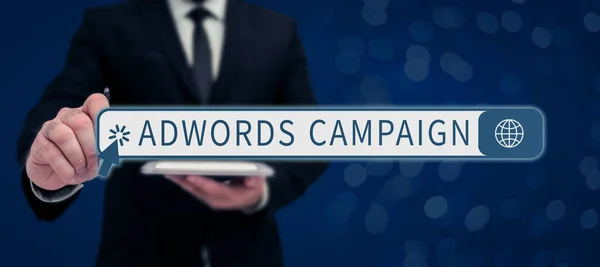 Sign displaying Adwords Campaign, Business showcase saying that you can do something at every place and moment Businessman in suit holding tablet symbolizing successful teamwork.