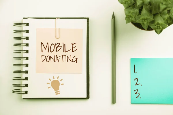Text sign showing Mobile Donating, Business concept to give something to a charity or any cause using personal devices
