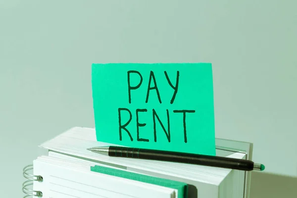 Hand writing sign Pay Rent, Word for To pay money in exchange for the use of someone elses property