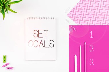 El yazması işareti, Hedefleri Ayarla, Planı temel alarak gelecekte bir şeyler başarmak ya da tanımlamak üzerine yazılmış Sözcük