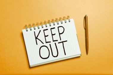 Hand writing sign Keep Out, Word for to stop someone or something from going into a place Danger sign