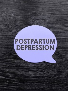 Writing displaying text Postpartum Depression, Word for a mood disorder involving intense depression after giving birth