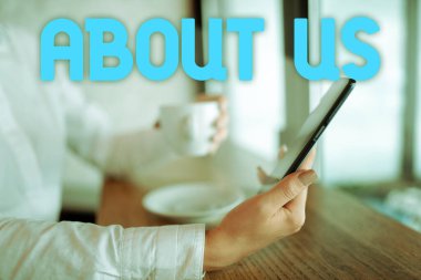 Hand writing sign About Us, Internet Concept to introduce who or what something relates to or concerns