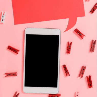 Important Message Presented On Phone On Desk With lothespins, Paper.