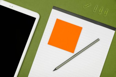 Mobile Phone Lying on Desk. Important infrormation written on paper.