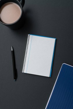 Coffee Cup Standing on Desk. Important infrormation written on paper.
