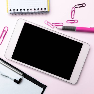 Phone With Important Message On Desk With pens, Calculator And Notebook.