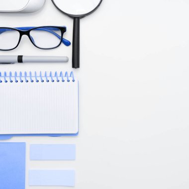 Office Supplies Over Desk. Keyboard and Glasses. Assorted School Utilities