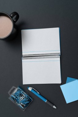 Coffee Cup Standing on Desk. Important infrormation written on paper.