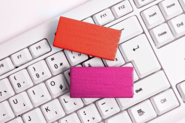 Colored cube with important message lying on keyboard. Main information.