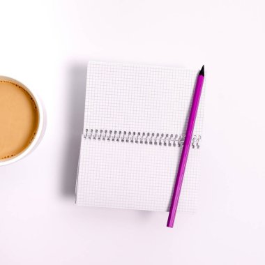 Coffee Cup Standing on Desk. Important infrormation written on paper.