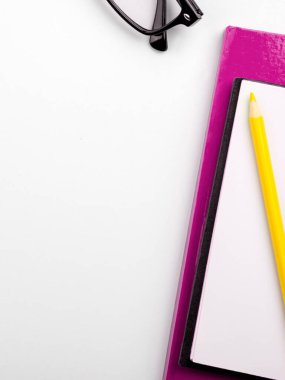Office Supplies Over Desk. Keyboard and Glasses. Assorted School Utilities