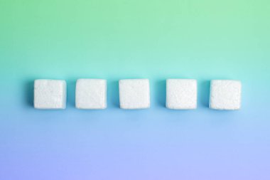 White Styrofoam Cubes Lying on Coloured Desk. Brand new Information.