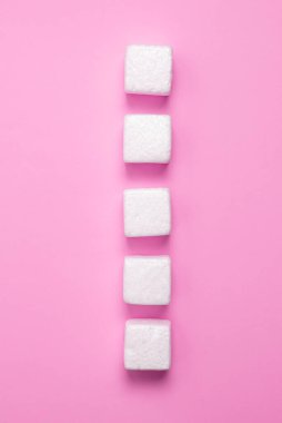 White Styrofoam Cubes Lying on Coloured Desk. Brand new Information.