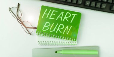 Hand writing sign Heart Burn, Business concept a burning sensation or pain in the throat from acid reflux