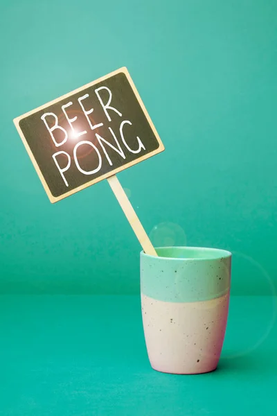 Text caption presenting Beer Pong, Word Written on a game with a set of beer-containing cups and bouncing or tossing a Ping-Pong ball