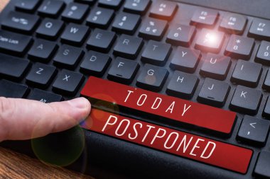 Text sign showing Postponed, Concept meaning to place later in order of precedence, preference, or importance