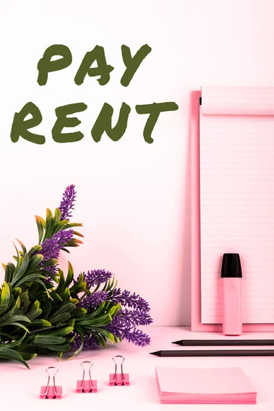 Writing displaying text Pay Rent, Concept meaning To pay money in exchange for the use of someone elses property
