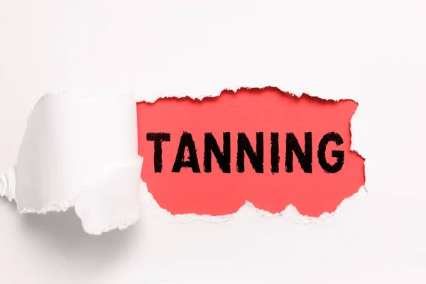 Writing displaying text Tanning, Concept meaning a natural darkening of the scin tissues after exposure to the sun